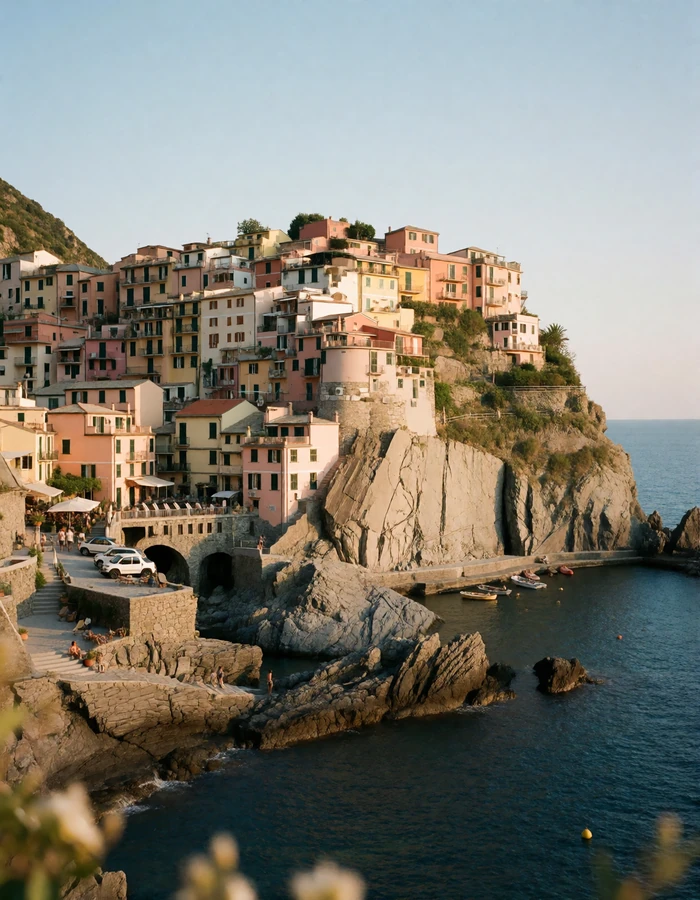 Pastel Italian cliffside village stacked above a deep blue cove with lemon terraces and stone stairways